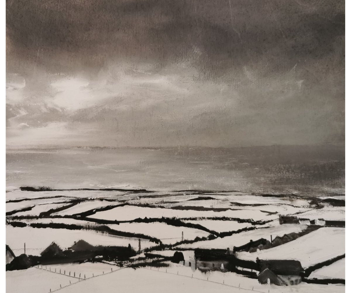 Moonlight over Rhossili - snow covered buildings and patchwork fields stretch down to the grey sea
