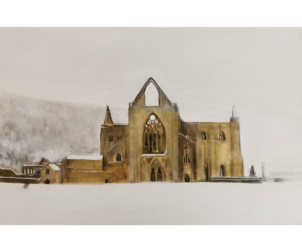 Tintern Abbey - the golden ruins of the medieval abbey glow against a pale backdrop